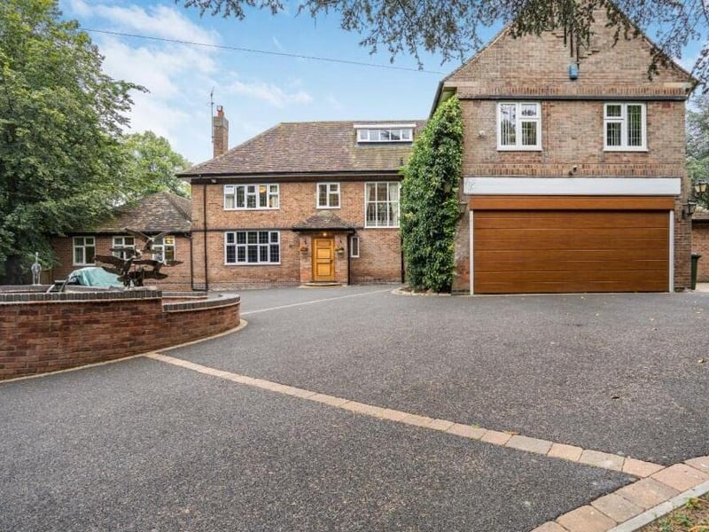 Let's rake a look outside the property now, beginning with the front driveway, which offers ample off-street parking space, and leads to a large double garage. To the left is a fountain, with koi fish swimming beneath.