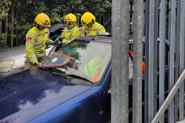 Firefighters practice dealing with a car crash.