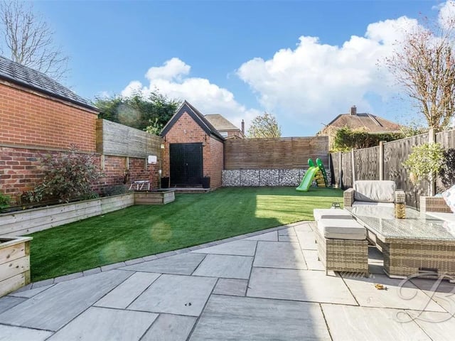 The rear garden is a highlight of the home, offering a space that is both practical and beautiful. It features an artificial lawn, patio seating area and fence surround - perfect for BBQs during the summer.