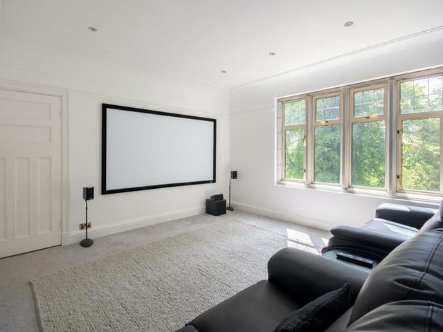This bedroom is currently being used as a cinema room. It has downlights and windows facing the front of the property.