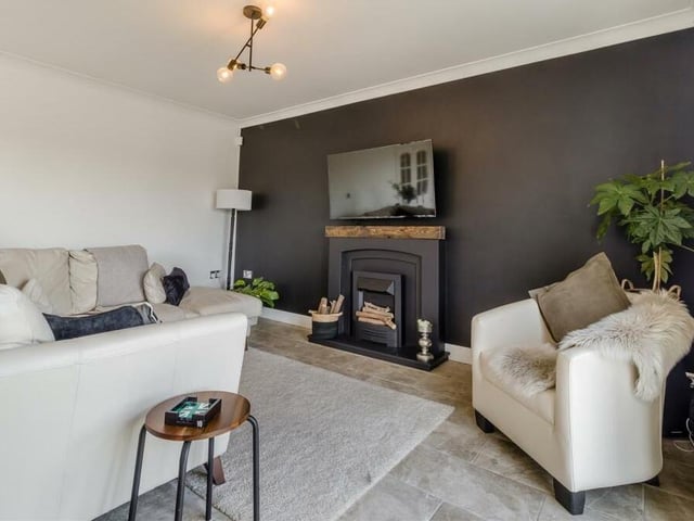 Relax in front of the feature fireplace, with inset electric fire, hearth and mantelpiece above.