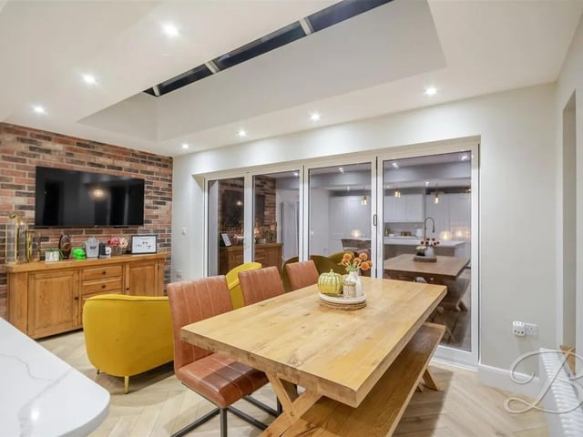 The kitchen flows seamlessly into a cosy breakfast area, bathed in natural light, creating an inviting setting for casual family meals or morning coffee.