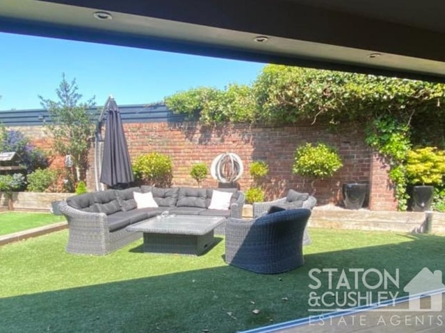 Let's have a look around outside now. This is the enticing view from the bi-folding doors in the lounge