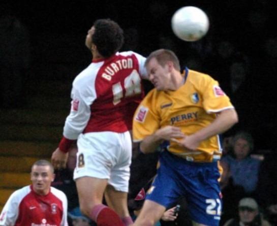 Deon Burton challenges in the air with Jon-Olav Hjelde in 2005