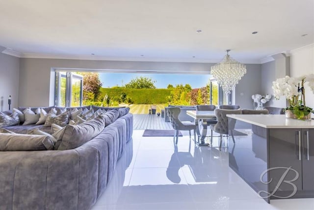 Large bi-folding doors in the open-plan hub present this spectacular sight, with the rear garden at the Derby Road property stretching before you.
