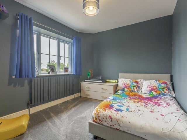 Splashes of colour turn the second upstairs bedroom into an attractive retreat. It has fitted carpets and a window overlooking the front of the house.