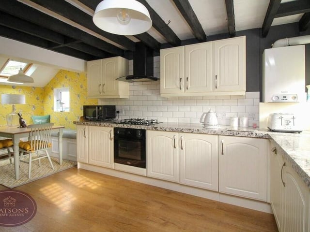 The dining kitchen has been newly-fitted as part of the partial refurbishment of the cottage. It includes a range of matching wall and base units, while integrated appliances include an electric oven and five-ring gas hob with extractor over, a washing machine and dishwasher. There is also a wall-mounted boiler.