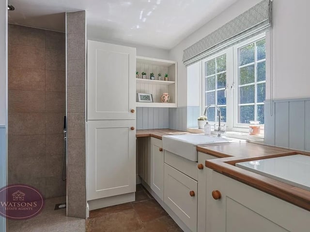 Convenience is king thanks to the separate utility space with a range of wall and base units, worksurfaces with inset Belfast style sink, plumbing for washing machine and mains fed walk in shower.