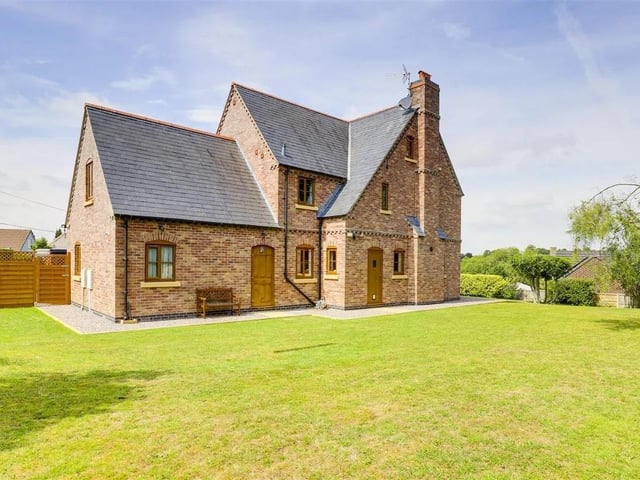 Outside, the property sits on a substantial plot with a wrap-around garden, featuring a well-maintained lawn.