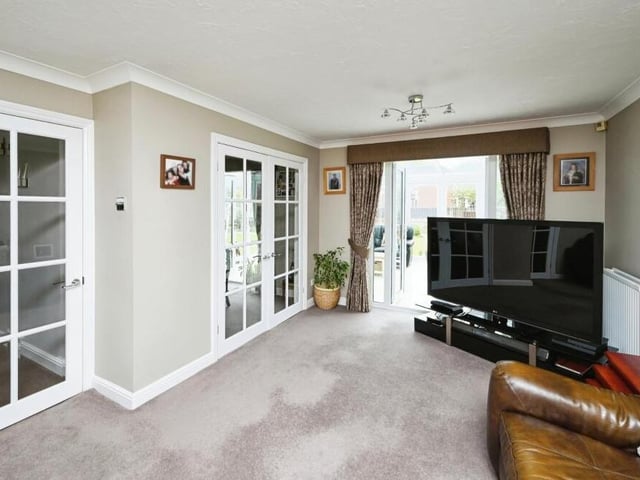 The main reception room is this spacious living room, which is bathed in natural light thanks to large windows and doors that lead from the hallway, dining room and conservatory.