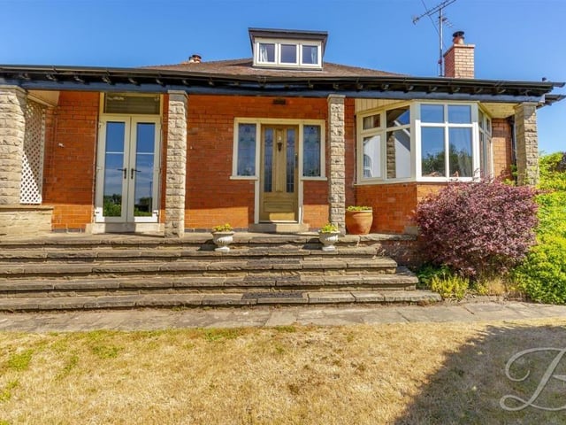 We complete our gallery with several photos of the exterior, beginning with the bungalow's fine ranch-type frontage. Steps lead to the front door, while the attic peers through the roof.