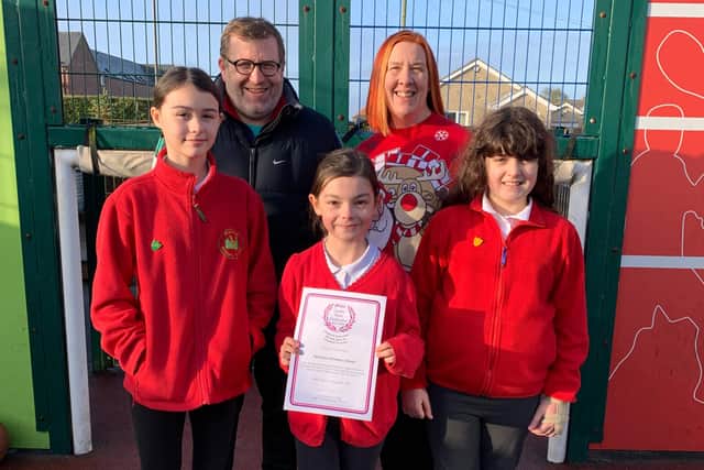 Palterton Primary School pupils pictured alongside David Whittaker, PE lead, and headteacher Ros Horsley, with the AfPE quality mark award.