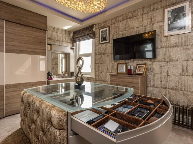 Dress like a movie star with the help of this regal dressing room off the master suite