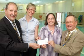 Mike Neville, left, and Mansfield Rotary Club president,  Ray Malkowski,  present a £1552.60 cheque to Michele Pulford, second left, the NCC School Swimming manager and Sandra Warner manager of Rainworth Social Enterprise. The money was used to buy disabled access steps for the community pool.