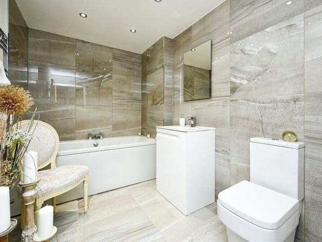 Our look at the second floor of the three-storey house is completed by this spacious and modern family bathroom. It consists of a bath with central taps, a vanity wash hand basin, WC, heated towel-rail and tiled flooring.