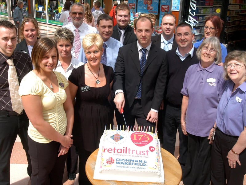 Lee Greenwood Shopping centre manage (centre) cuts the cake to celebrate 175 years of the Retail Trust at the Idlewells shopping centrein 2007. Pictured with him are retail managers at the centre.