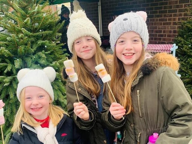 Visitors keeping warm with toasted marshmallows.