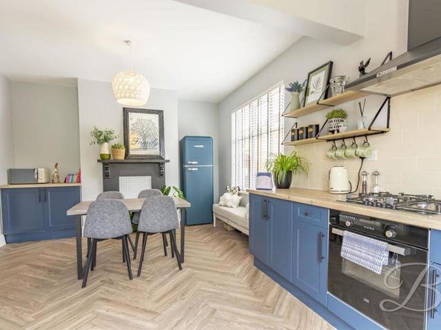 Our photo gallery begins in this tasty kitchen/diner, which comes complete with a range of attractive units and cabinets. There is space for a fridge/freezer and a dining table, while the herringbone-style floor adds a nice touch.