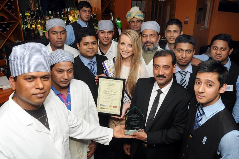 Miss Mansfield Chelsea Edgington with Mutahear Chowdury, owner of The Chand in Mansfield, pictured with the restaurant's latest award and staff members.






.