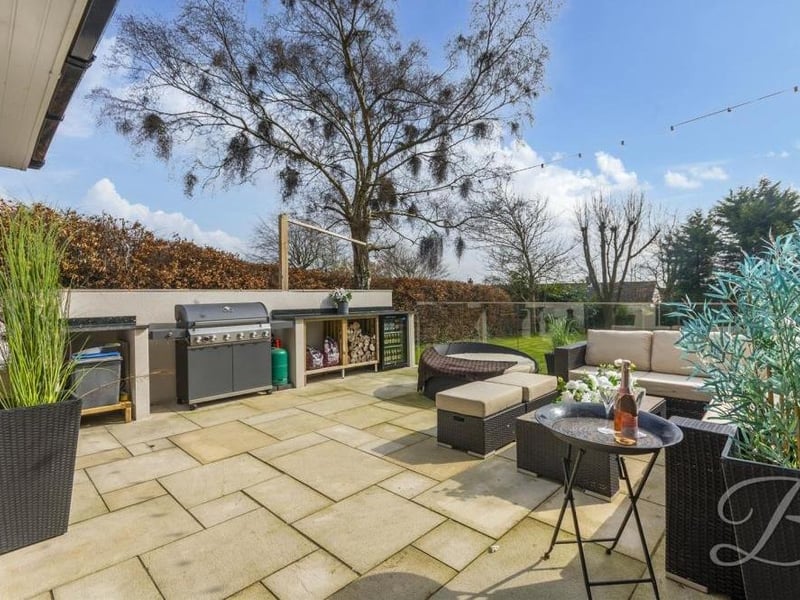 A dominant feature of the back garden is this fitted kitchen with hot and cold water, Belfast sink and substantial marble worktop for food preparation. There is even space for a barbecue and a fridge.