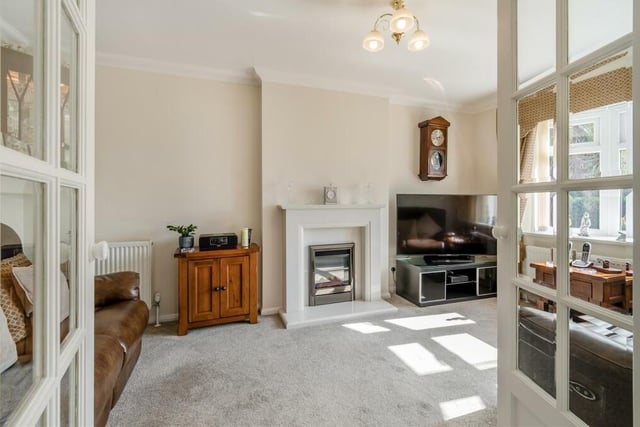 As one set of doors is flung open, you are welcomed into the lounge, which is the main reception room at the £230,000 bungalow.