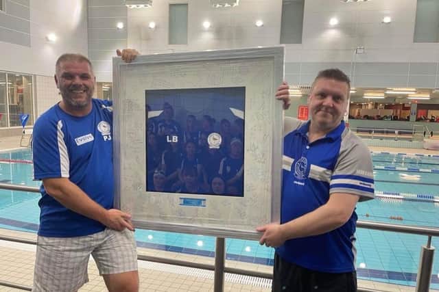 Lee receives a signed and framed club tee-shirt from club chair Paul Jones.