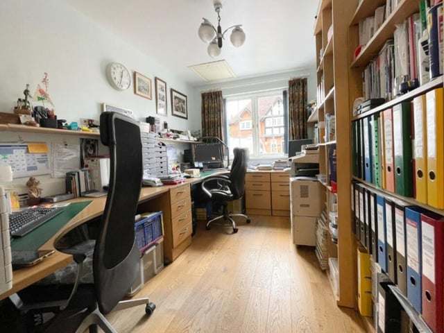 Two of the bedrooms at the £650,000 property can be found on the ground floor. But this one is currently being used as an office. It has lots of storage space and an oak floor.