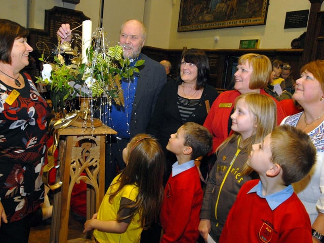 In 2009 Rev Paul Bentley, Chaplain to the John Eastwood Hospice, pictured at the switch on for the S.H.I.N.E. Tree of Lights at Queen Elizabeths School. Also pictured from the left are S.H.I.N.E. members Sue Welton, Elizabeth Woods, Hilary Canham and Sandra Wilkins. Children pictured are; Ebony Peters and Marie Kirkb from St Augustines Brownies and Oliver Bloodworth and Cameron Rocky-Clewlo from St Peters School Choir