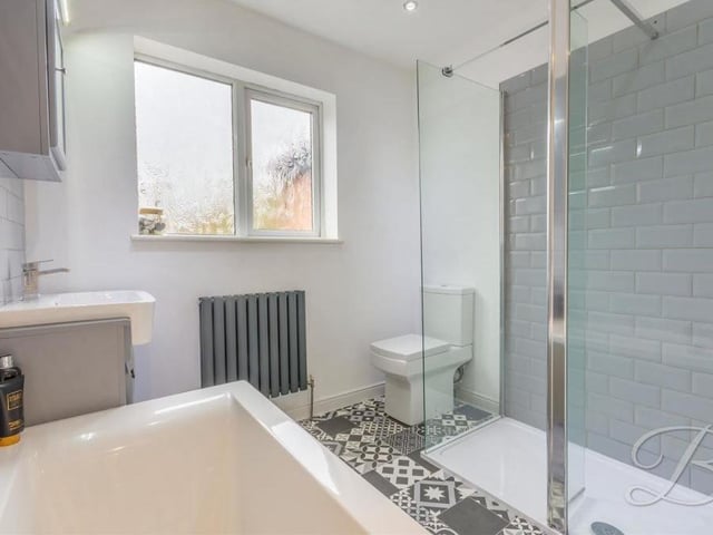 The family bathroom is a smart-looking space on the first floor. It comprises a panelled bath, low-flush WC, walk-in shower with Metro tiles, wash hand basin and downlights.