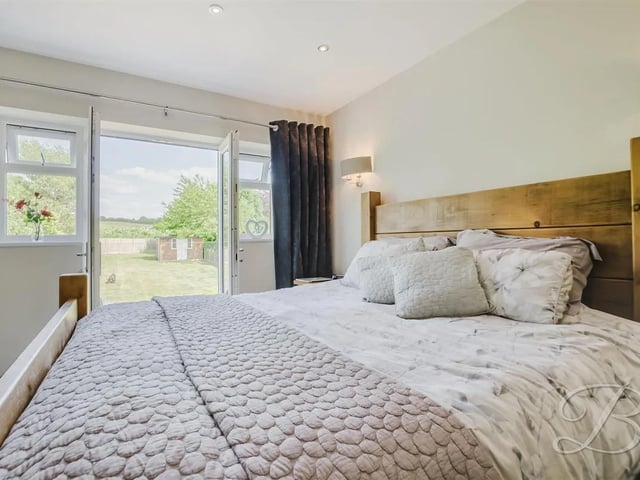 Featuring carpeted flooring, central heating radiator, walk in wardrobe, en suite and a juliet balcony overlooking the rear garden.