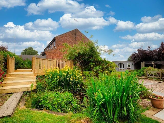 Another shot of the delightful garden at the £475,000 house, with steps leading up to the decking space.