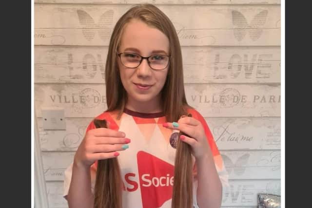 Alicia holding her hair which will be donated to the Little Princess Trust