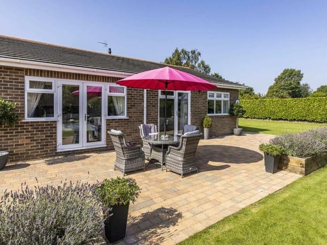 The sun is shining, so what better place to unwind and relax than this pleasant patio, which has space for seating?