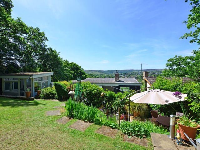 In the garden is also a summer house with a patio, a garden shed, with adjoining woodland, with winding paths and gated access. The rear also benefits from a parking space off Woodland Place.