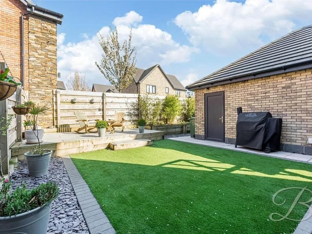The rear garden is mainly laid with artificial lawn with fence surround offering a degree of privacy and features a paved patio seating area.