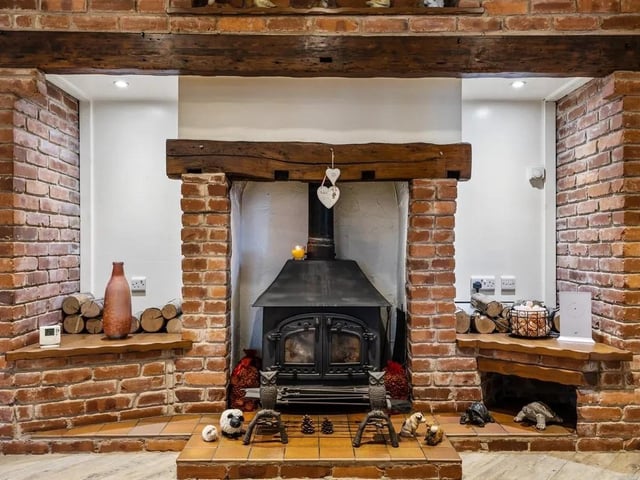 The focal point of the living room is the Inglenook brick fireplace