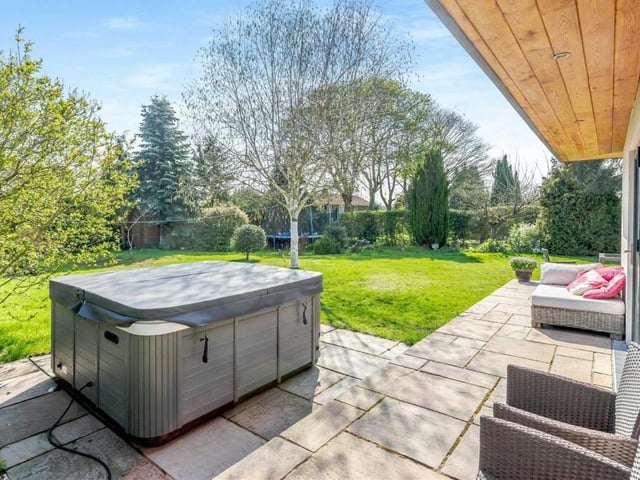 The sunny back garden offers not only pleasant seating areas but also space for a hot tub.