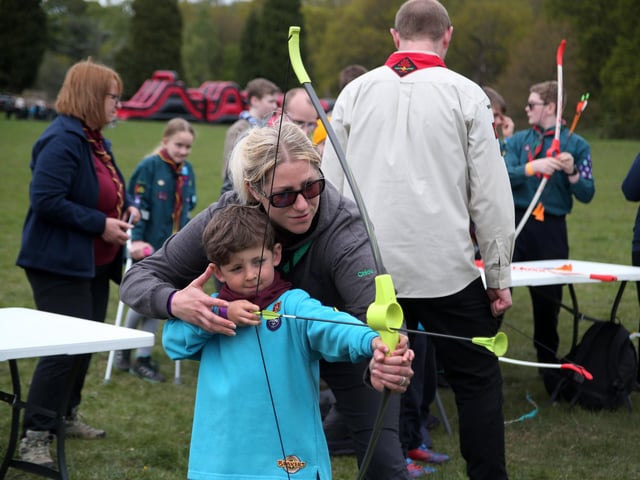 1st Kirkby beaver Rhys Morgan tries his hand at archery, helped by Akela Chloe Aram, at Newstead Abbey in 2019.