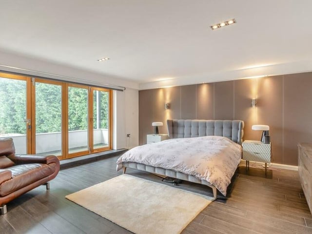 The second bedroom at the Coxmoor Road property is another sizeable double with access, via large, glazed doors, to the decked patio. A feature wall, a Porcelanosa plank tile floor and underfloor heating are familiar assets.