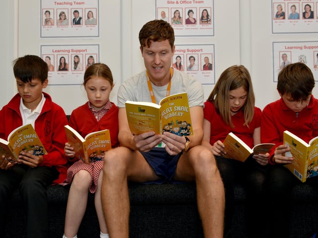 Annesley Primary School PE teacher Daniel Henshaw has written a childrens book, Daniel is pictured reading with pupils Zachary den Dopper, nine, Isobelle DuBois, nine, Eve Jackson, nine and Harrison Matthews, eight. Pictured in 2017.