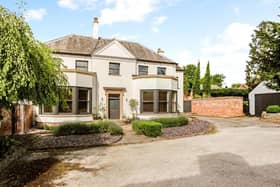 This magnificent Georgian family home is on the market at a guide price of £1,175,000. It has been superbly restored and renovated by the current owners. As you can see, the frontage features mature flowerbeds and shrubs with small trees and a paved pathway, all partially enclosed by brick walling.