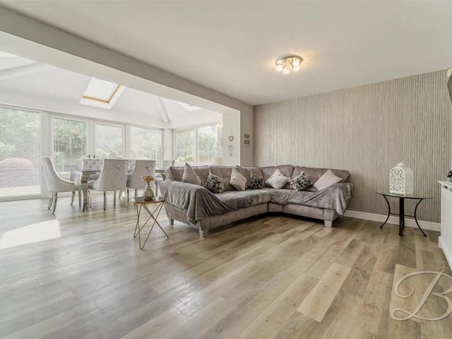 The open plan kitchen/dining space flows effortlessly into a cosy living area with space for a sofa,