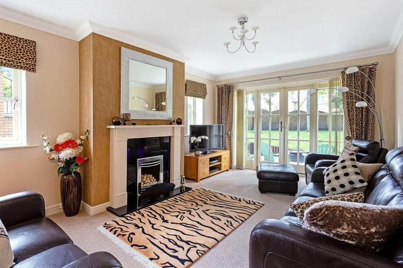 The sitting room, nestled in a rear corner of the property, is a lovely, bright space. Its focal point is a fireplace with granite hearth, inset gas fire and stone surround and mantelpiece. Large French doors lead out to the garden.
