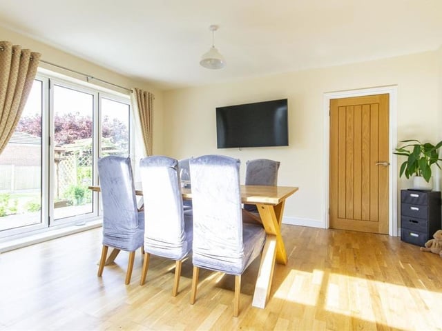 A second shot of the bright and relaxing dining area, with its laminate flooring.