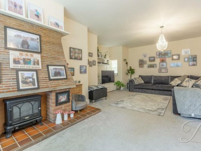 This second shot of the lounge shows the feature fireplace. There are also three central heating radiators, making it a warm and cosy space, despite its size.