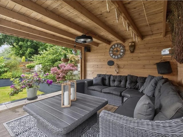 There is a central lawn and steps leading up to an undercover gazebo with decked floor which provides a lovely outdoor entertaining space with steps leading back down to the patio