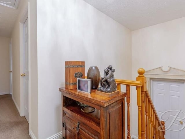 At the top of the stairs, you are greeted by this first-floor landing, which has a fitted carpet and leads to all four bedrooms..