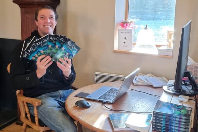 Debut author Tom Elliott with copies of his book.