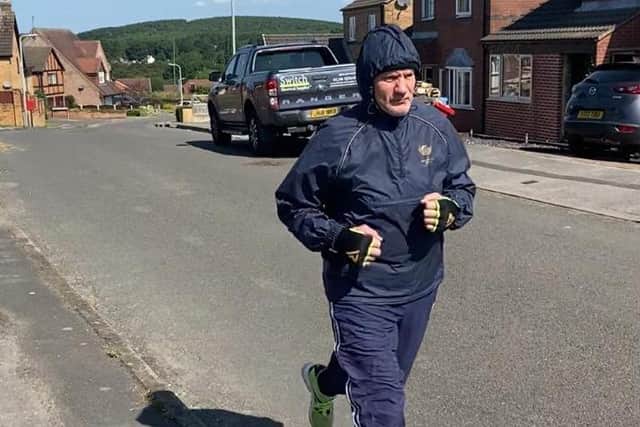 Steve Ward pouding the streets in training in the summer heat.