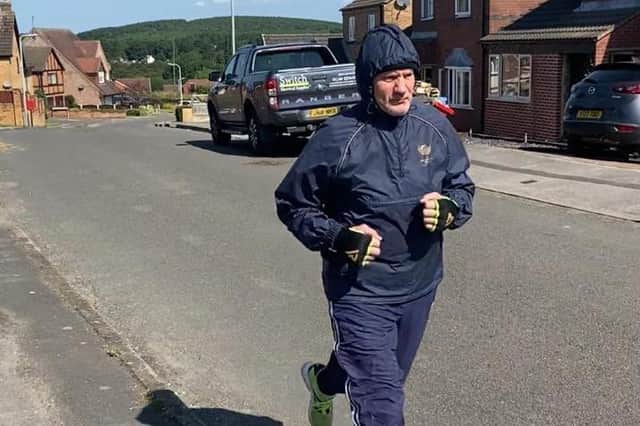 Steve Ward pouding the streets in training in the summer heat.